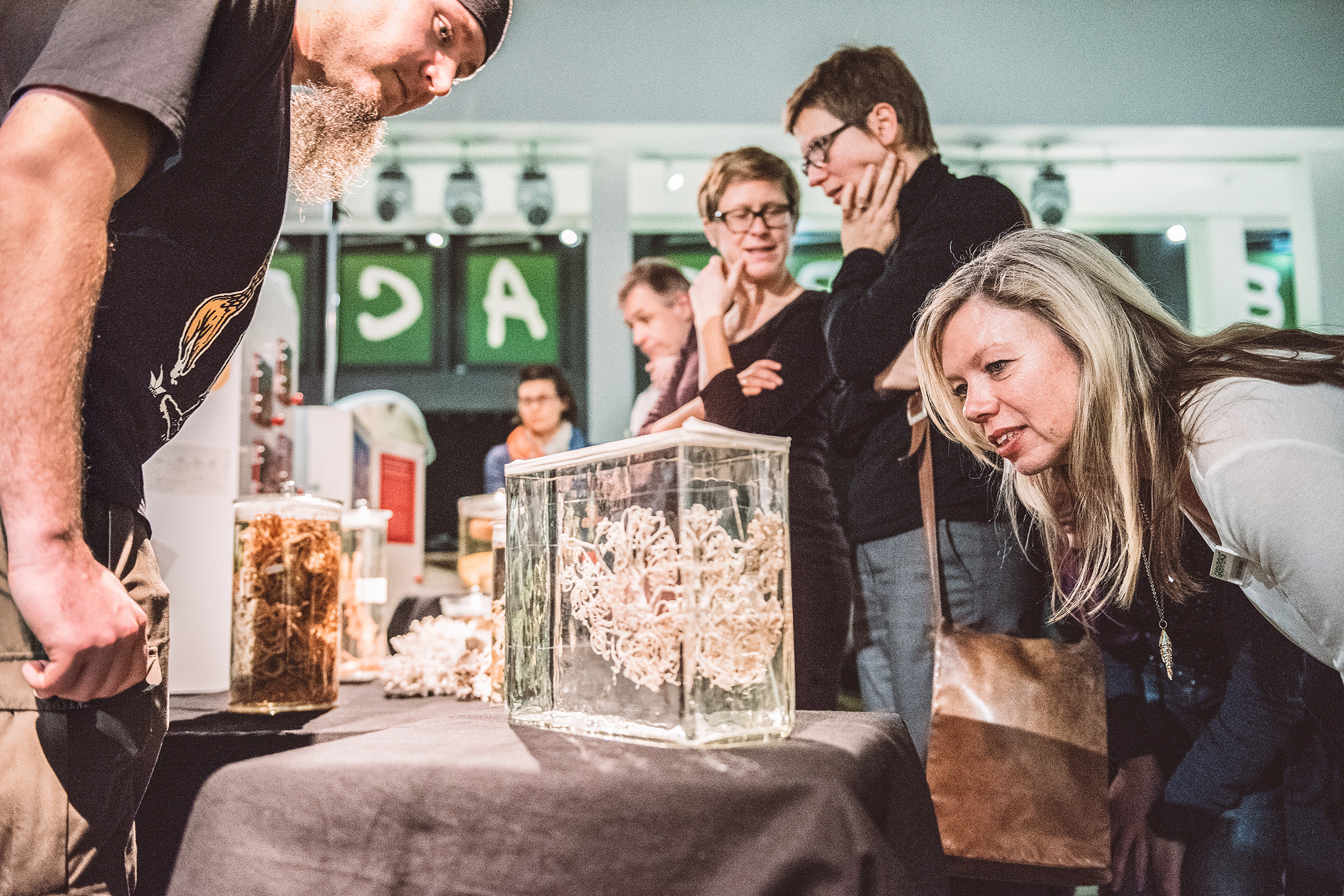 Eine Besucherin sieht sich ein Exponat an bei einem Greenpeace Event in Hamburg und wird dabei von einem professionellen Veranstaltungsfotografen aufgenommen